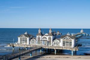 a building on a pier in the water at Ferienwohnung Weitblick mit Logia in Lobbe