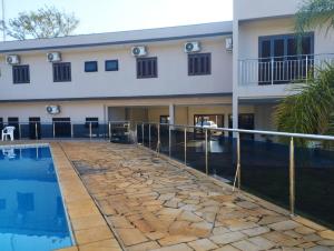 a villa with a swimming pool and a building at Senior Parque Hotel in Santa Rosa