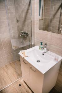 a bathroom with a white sink and a shower at Vikendica Jure Blidinje Ski&Nature in Čuljci