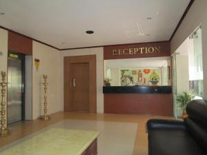 a lobby of a hospital with a reception door at Hotel Subam in Palni
