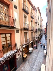 a city street with buildings and people walking down the street at Apartamentos Laurel in Logroño