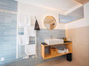 a bathroom with a sink and a mirror at Apartment Roman by Interhome in Stams