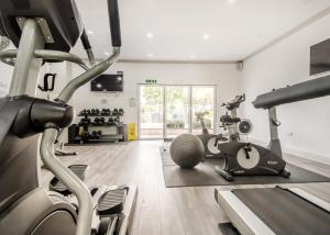 a gym with treadmills and exercise bikes in it at Alder Country Park in North Walsham