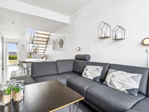 a living room with a couch and a table at Apartment Kimi - 100m from the sea in Western Jutland by Interhome in Havneby