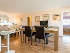a dining room and living room with a table and chairs at Apartment Cap Cabourg-31 by Interhome in Cabourg +13 photos