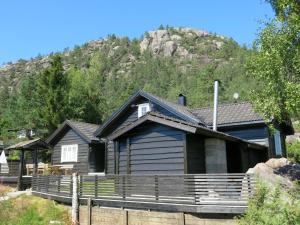 a house with a fence in front of a mountain at Holiday Home Friabu - SOW143 by Interhome in Fossdal