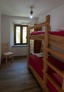 a room with two bunk beds and a chair at Borgo Don Camillo in Cutigliano