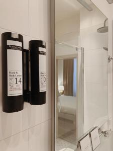 a bathroom with a mirror and two black buffers at La Lys Rooms & Suites in Ghent +63 photos