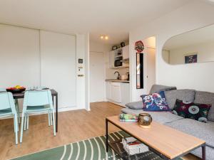a living room with a couch and a table at Apartment Le Domaine du Vert Coteau by Interhome in Touques