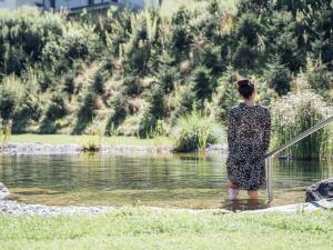 a woman standing in a body of water at Apartment Theo by Interhome in Stams