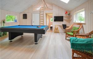 a living room with a pool table in a tiny house at Awesome Home In Hjerm With Wifi in Hjerm