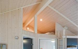 a room with a wooden ceiling and a room with a door at Holiday Home Houmøllevej in Karby