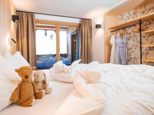 two teddy bears sitting on a bed in a bedroom at Apartment Greta by Interhome in Stams