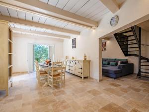 a kitchen and living room with a table and a couch at Holiday Home Malanuit by Interhome in Bauduen +26 photos