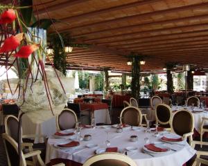 a dining room with white tables and chairs at Casa Quiquet in Beniparrell