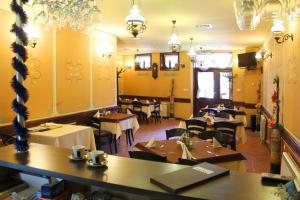 a dining room with tables and chairs in a restaurant at Family Hotel at Renaissance Square in Plovdiv