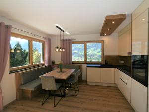 a kitchen and dining room with a table and chairs at Apartment Mäuerlhof by Interhome in Hart im Zillertal