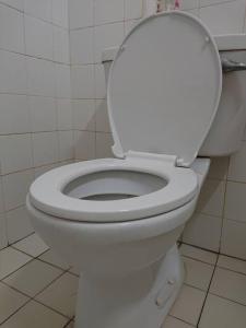 a bathroom with a white toilet with the lid up at Butterworth homey House (3R2B + carpark) in Butterworth