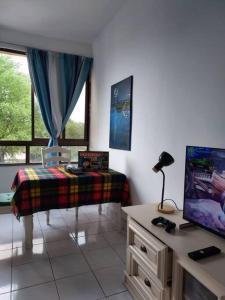 a living room with a tv and a window at Butterworth homey House (3R2B + carpark) in Butterworth +18 photos