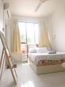 a bedroom with a bed and a window and a ladder at Butterworth homey House (3R2B + carpark) in Butterworth