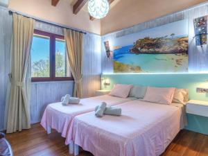 - une chambre avec 2 lits et un tableau mural dans l'établissement Villa Sa Teulada by Interhome, à Santa Margalida