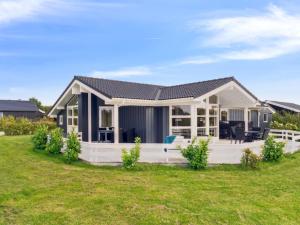 a small house with a large backyard at Holiday Home Skaghi - 500m from the sea in Sealand by Interhome in Føllenslev