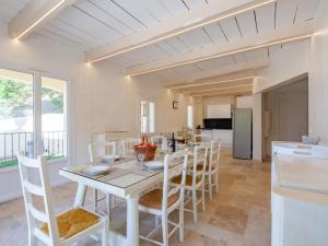 a kitchen and dining room with a table and chairs at Holiday Home Marges by Interhome in Bauduen