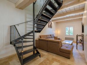 a living room with a staircase and a couch at Holiday Home Marges by Interhome in Bauduen