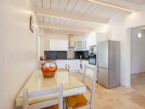 a kitchen with a table and a refrigerator at Holiday Home Marges by Interhome in Bauduen +26 photos