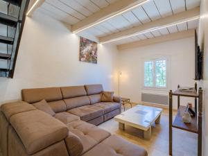 a living room with a couch and a table at Holiday Home Marges by Interhome in Bauduen