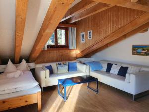 a living room with two couches and a table at Apartment Casa Fadail Seura 21 by Interhome in Lenzerheide