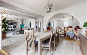 a dining room and living room with a table and chairs at 4 Bedroom Gorgeous Home In Jarnac in Jarnac