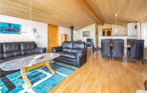 a living room with a couch and a table at Awesome Home In Snedsted With 3 Bedrooms in Snedsted