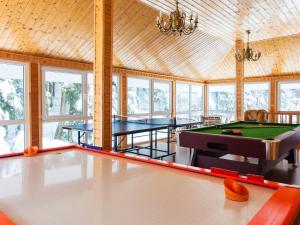 a pool table in a room with windows at Holiday Home Antoś by Interhome in Baligród