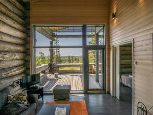 a living room with a door open to a deck at Holiday Home Kiehinen 1 by Interhome in Saariselka