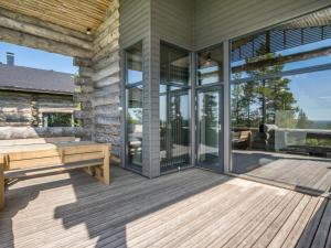 a wooden deck with a bench on a house at Holiday Home Kiehinen 1 by Interhome in Saariselka