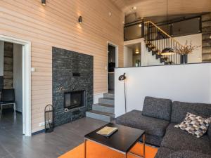 a living room with a couch and a fireplace at Holiday Home Kiehinen 1 by Interhome in Saariselka +21 photos