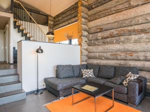 a living room with a couch and a table at Holiday Home Kiehinen 1 by Interhome in Saariselka