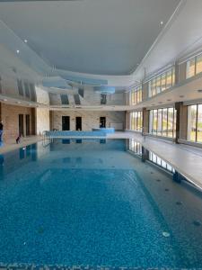 a large swimming pool in a large building at Lovely SPA 31 in Dziwnów
