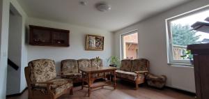 Zimmer mit Stühlen, einem Tisch und einem Fenster in der Unterkunft Haus Oderbruch in Neulewin