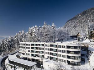 a hotel in the snow with a mountain at Apartment Sonnentanz alpe maritima Ski & See-Top 2 by Interhome in Annenheim
