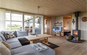 een woonkamer met een bank, een tafel en een tv bij Nice Home In Lemvig With Wifi in Lemvig