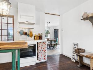 a kitchen with white appliances and a dining room at Holiday Home Quiana - 4km from the sea in NW Jutland by Interhome in Torsted