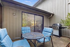 a patio with chairs and a table and a grill at Tennismaster 505 in Hilton Head Island