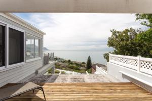 a balcony of a house with a view of the ocean at Paradise Views Vacation Home in Cape Town