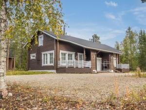 a house with a large driveway in front of it at Holiday Home Kuurankuksa a by Interhome in Sirkka