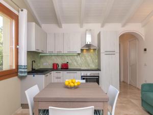 una cocina con una mesa con un bol de fruta. en Holiday Home Romeo by Interhome, en Budoni