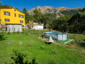 a house and a boat in a field next to a house at Holiday Home Maya e Stella by Interhome in Bagni di Lucca