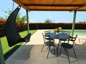 a patio with a table and chairs and a hammock at Apartment Rina by Interhome in Cortona