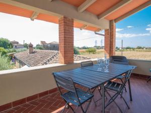a blue table and chairs sitting on a patio at Apartment Rina by Interhome in Cortona